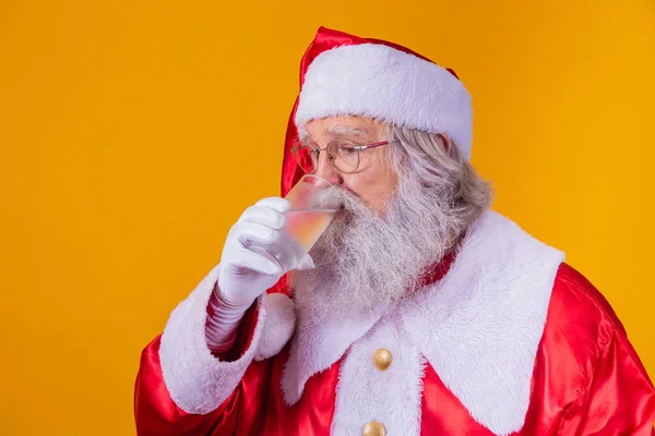Der Weihnachtsmann Trinkt Ein Glas Wasser Auf Gelbem Hintergrund Mit — Stockfoto