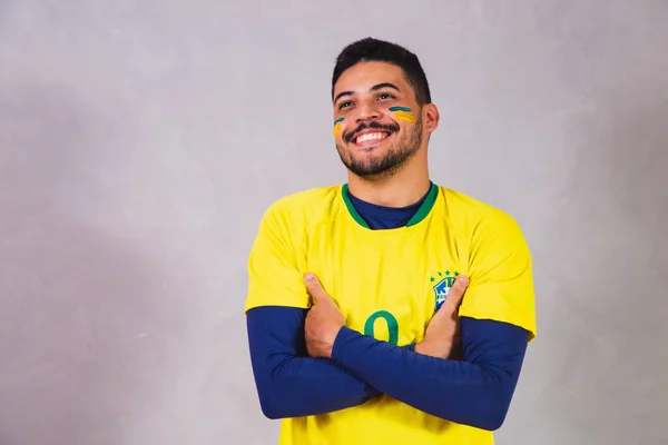brazilian fan wearing costume for the world cup. Brazilian male fan in brazilian clothes