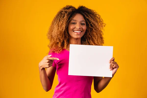 Woman shows empty board. Advertising board. Black friday. Advertising. Smiling woman holds empty advertising banner. Ready for your text. Sale and discount. Season sales.