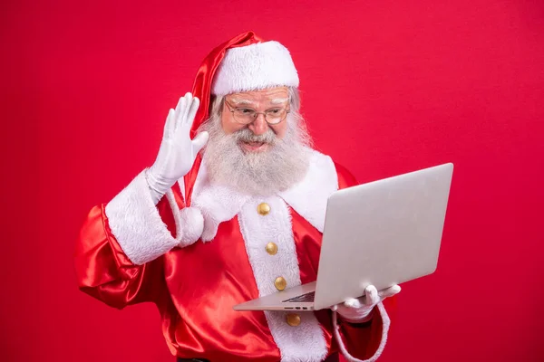 Santa Claus Using Laptop Red Background — Stock Photo, Image