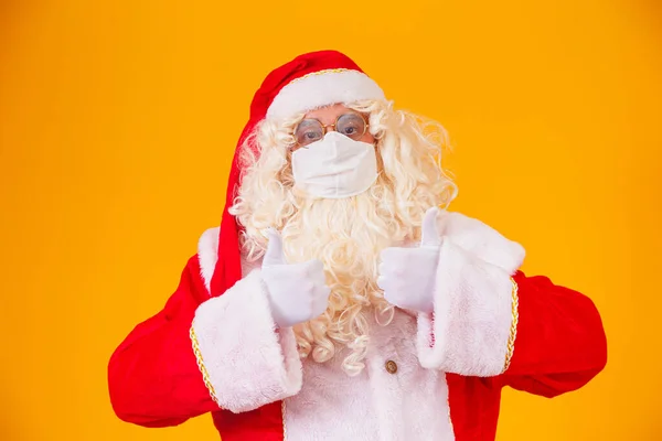 真正的圣诞老人 背景是黄色的 戴着防护面具 遮挡着棺材 有社交距离的圣诞节 Covid — 图库照片