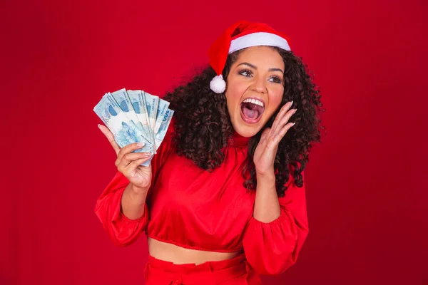 stock image Afro woman counting Brazilian money bills. Real notes. 100 reais bills. Savings concept for the end of the year. Spend the Christmas. Spent on Christmas gifts.