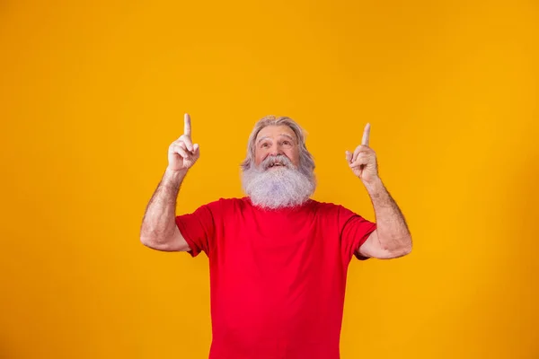 old man with long beard with fingers pointing up in free space for text.