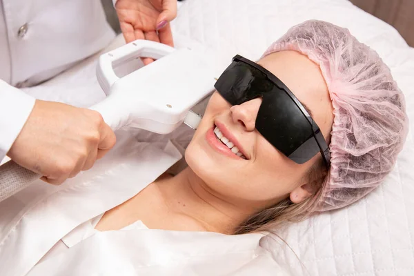 stock image Woman in professional beauty salon during photoepilation procedure