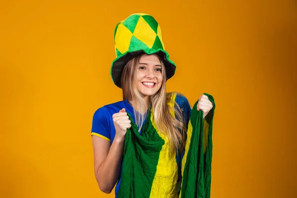 ブラジルの旗で黄色の背景を祝うブロンドブラジルのファン — ストック写真