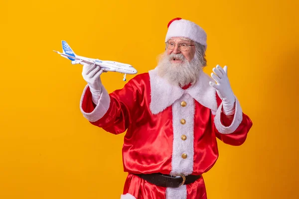 Santa Claus Holding Little Toy Airplane Yellow Background Christmas Travel — Stock Photo, Image