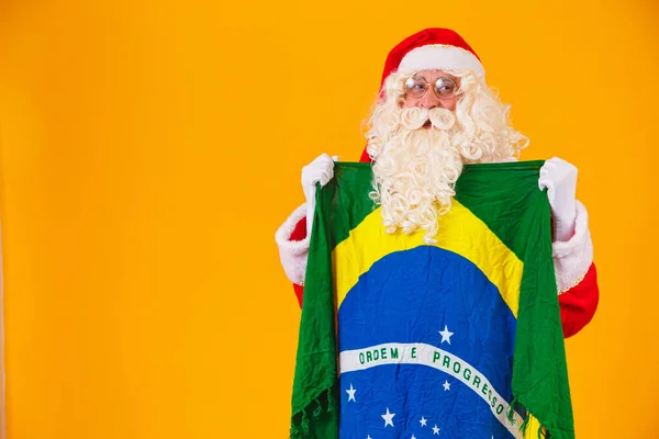 stock image Santa Claus is a fan of Brazil. Santa Claus supporter of the Brazilian team. Sports championship. Santa Claus holding the brazilian flag. Soccer match.