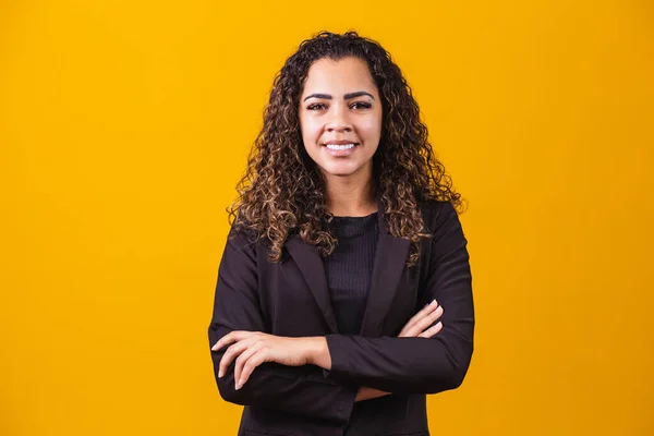 Afro Business Woman. Confident black woman in suit posing with folded arms on yellow background, horizontal banner, wide long shot, panorama