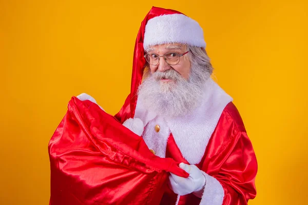 stock image Curious real Santa looking into the gift bag