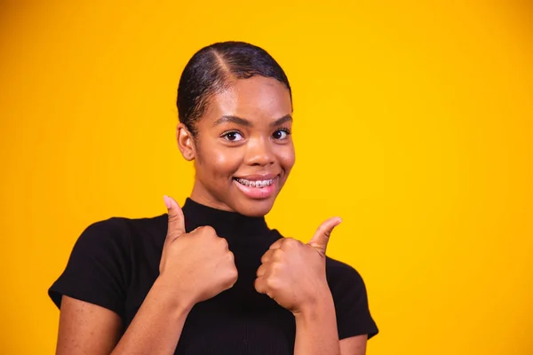 Black Woman Yellow Wall Giving Thumbs Gesture Because Something Good — Stock Photo, Image
