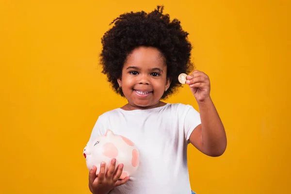 Little Girl Saving Money Piggybank Yellow Background — Stock Photo, Image