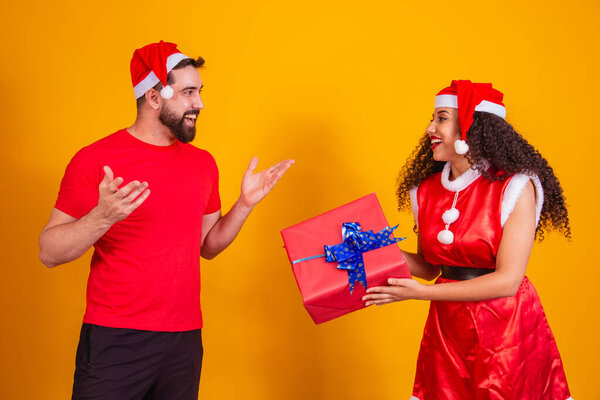 Young couple of lovers exchanging gifts on Christmas. Merry Christmas