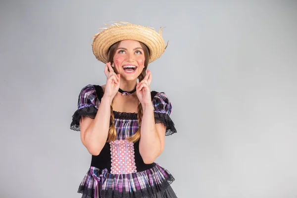 stock image Blonde Brazilian woman, June party clothes, arraial. good luck, fingers crossed.