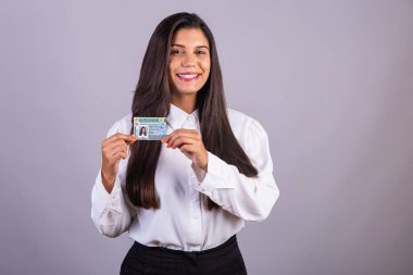 Brazilian businesswoman with driver's license. Translation in English (national driver's license) clipart