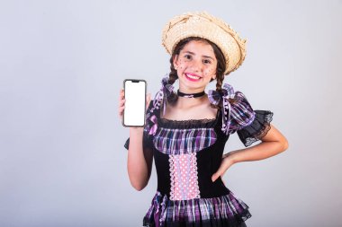 Kız, Brezilyalı, Festa Junina, Arraial, Festa de So Joao kıyafetleriyle. Yatay portre. Akıllı telefonla..