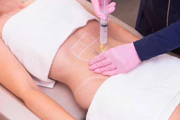 Esthetician, professional esthetician wearing lab coat, performing ozone procedure, application of ozone to the abdomen, ozone therapy, female patient. weight loss, slimming.
