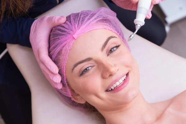 closeup photo of woman\'s face, photo of aesthetics, anti aging procedures. Plasma jet application. Aesthetics, spa. beautician.