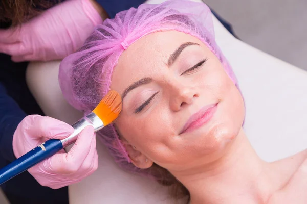 closeup photo of woman\'s face, photo of aesthetics, anti aging procedures. Application of cream mascara, hydration. Aesthetics, spa. beautician.