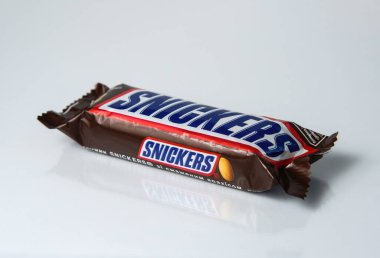 Zaporizhzhia, Ukraine - June 4, 2023: Snickers chocolate bar isolated on white background with reflection