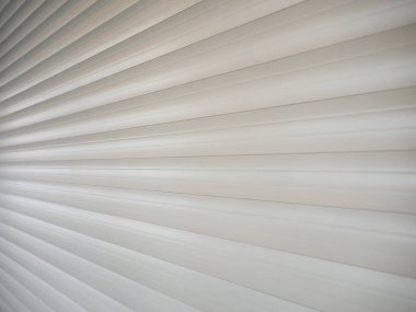 An angled view of the lowered white protective shutters. Background