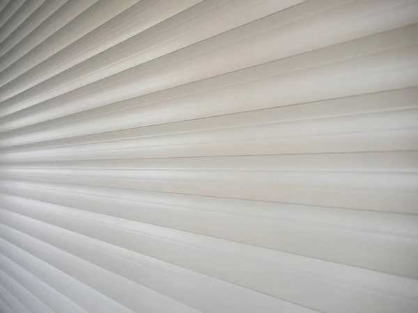An angled view of the lowered white protective shutters. Background