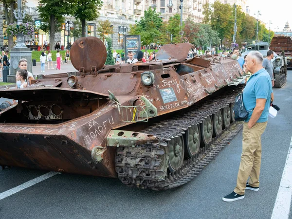 stock image Kyiv, Ukraine - August 26, 2023: An elderly man looks at the destroyed russian MT-LB (multi-purpose light armored transporter-tractor, Object 6, motolyga), exhibited on Khreshchatyk