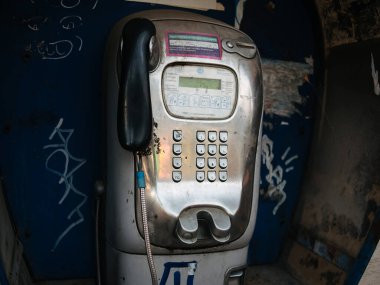 Lviv, Ukrayna - 29 Ağustos 2023: Akşam saatlerinde eski parlayan metal sokak ankesörlü telefon