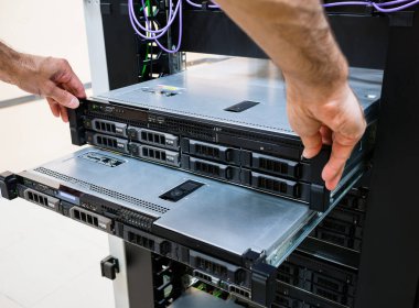 Maintenance of servers installed in a rack in the server room. The engineer pulled out the server blocks