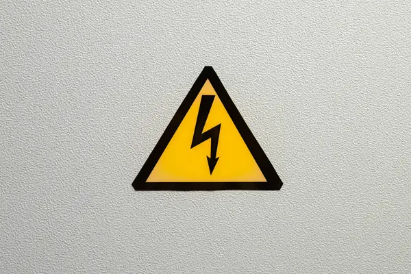 Triangular danger sign (black lightning on yellow background).