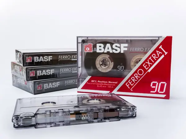 stock image Zaporizhzhia, Ukraine - July 28, 2024: Audio Cassette BASF FERRO EXTRA I 90 lying on the background of a stack of sealed in original packaging cassettes isolated on a white background