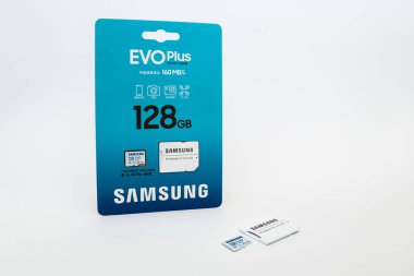 Zaporizhzhia, Ukraine - August 19, 2024: Samsung microSDXC Class 10 UHS-I U3 V30 A2 EVO Plus 128GB memory card and SD adapter in branded packaging and lying nearby without packaging, isolated on white background clipart