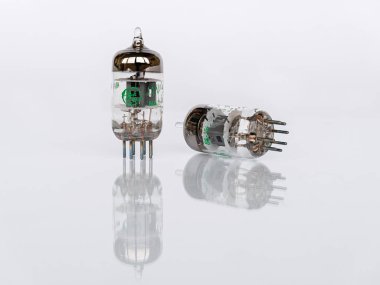 Zaporizhzhia, Ukraine - August 23, 2024: 7-Pin General Electric GE 5654W vacuum tubes isolated on white background with reflection clipart