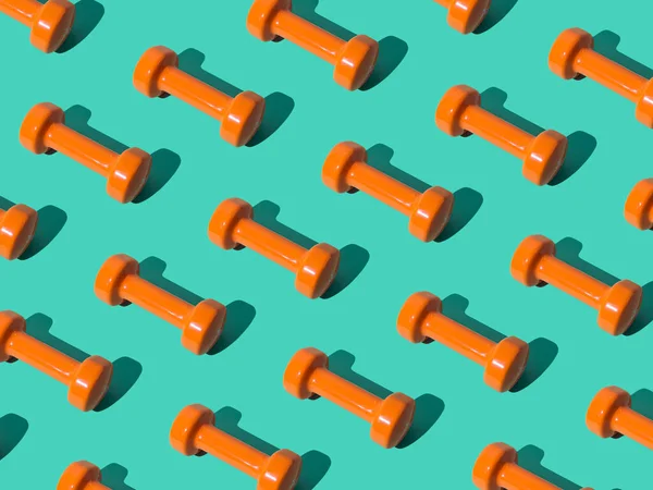 Creative pattern composition made of orange dumbbells on pastel green background. Minimal fitness, healthy lifestyle and sport concept. Trendy exercise and fitness backround idea.