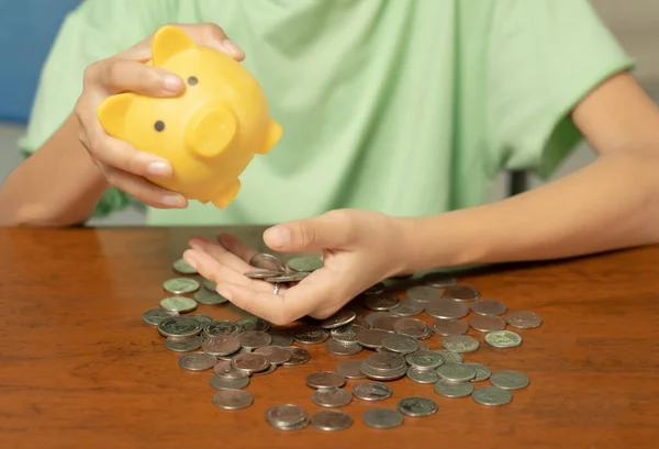 A piggy bank is a device that keeps money or savings in a safe place. And help accumulate money for various purposes such as education, travel or investment in the future . Coins.Savings Bank.close up