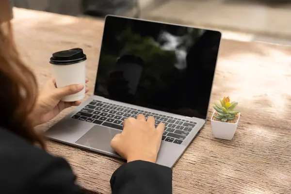 stock image busy businesswoman's skilled hand deftly juggled sleek tablet, a steaming cup coffee, and buzzing mobile phone, seamlessly multitasking to stay connected, informed, productive in her fast-paced world.