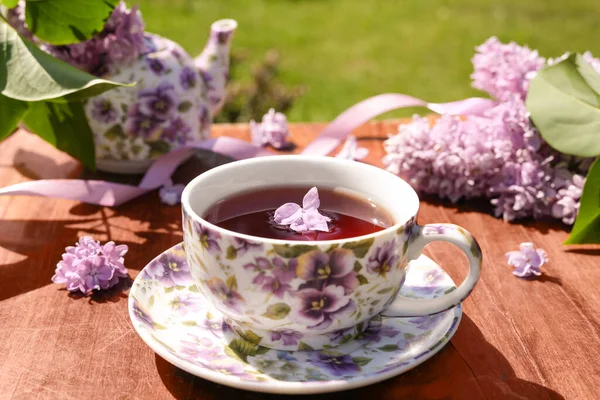 Spring Composition Purple Cup Flowers Teapot Lilac Flowers Light Background — Stock Photo, Image