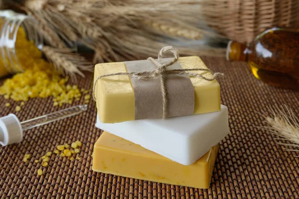 Handmade soap bars, sea salt and oats. Natural ingredients for homemade facial and body mask or scrub. Healthy skin care. SPA concept. Selective focus. Side view.