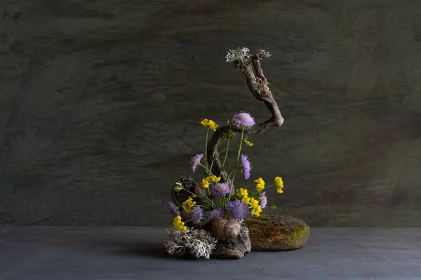 stock image delicate, sweet, miniature composition of wildflowers using roots, moss, lichen, naturalistic style.