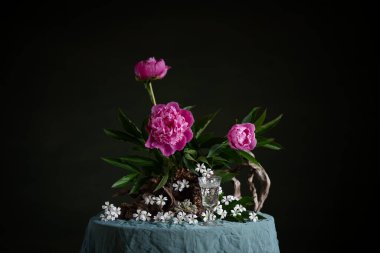 Zarif şakayıklar tam çiçeklenme, zarafet ve yumuşaklık yayar, dalları ve dalları olan ince bir filtodizayn kompozisyonu ile düzenlenir. Doğanın güzelliği ve sanatsal işçiliğinin uyumlu bir karışımı.