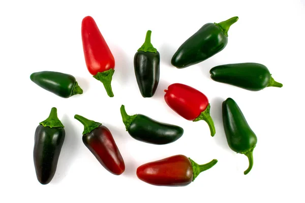 Flat lay of various colors of red and green jalapeno peppers