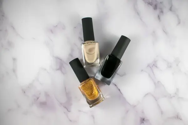 Background flat lay photo with multiple colors of nail polish