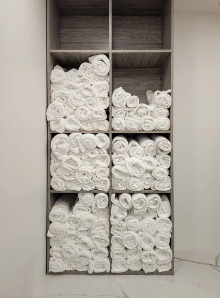 Close up photo of rolled fluffy clean towels at a luxury gym shower or spa pool