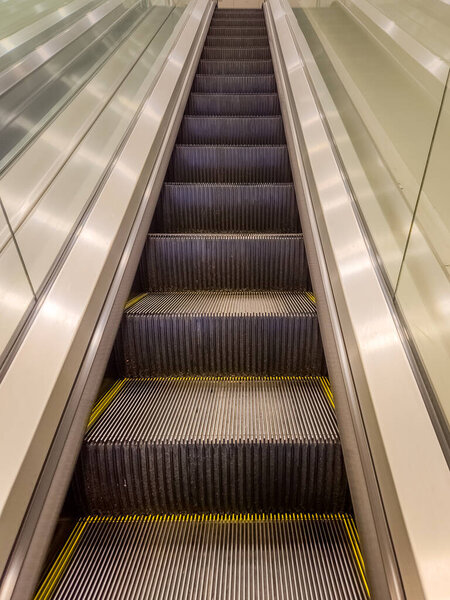 Stainless steel escalator going up stairs