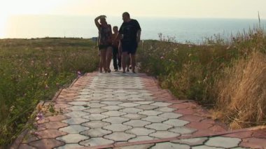 Snake Island 'da turizm - Bir grup turist yürüyüş sırasında asfalt bir yolda yürüyor. Karadeniz, Ukrayna.