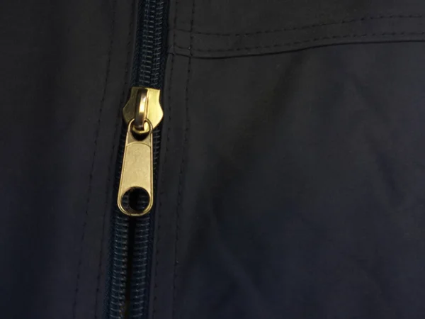 stock image The zipper is unzipped. Blue fabric with a large zipper