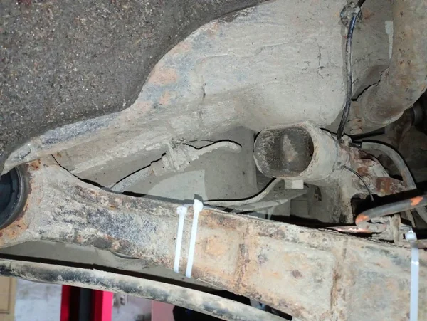Car suspension repair. Rusty beams that hold the wheel. Old suspension and repair of transport.