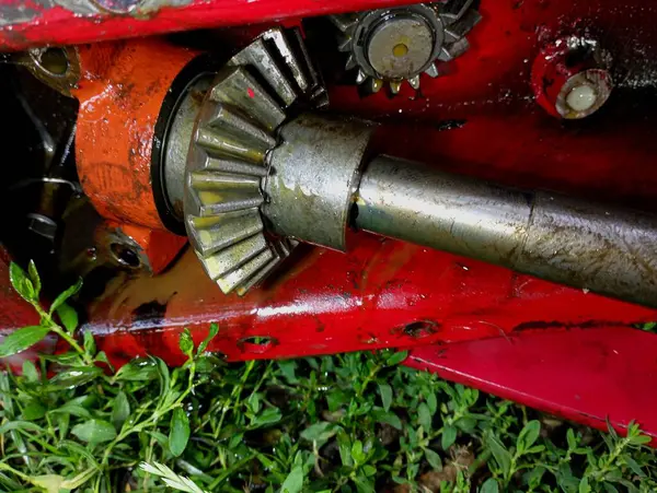 Stock image The mechanism of a tractor mower with a shaft and gears lubricated with solidol. Agricultural machinery for mowing grass and its repair.