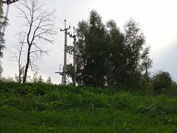 stock image A transformer on a power line on large concrete supports. The topic of electricity and power lines.