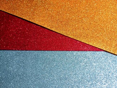 Dekorasyon yapmak için çok renkli, parlak, yumuşak malzemeler. Sarı, kırmızı ve gri dekoratif malzemelerin arka planı.