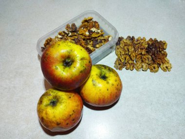 Still life with homemade apples and peeled walnut. homemade fruits and nuts. clipart